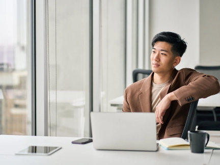 man behind desk with laptop