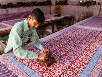 man block printing colourful fabric